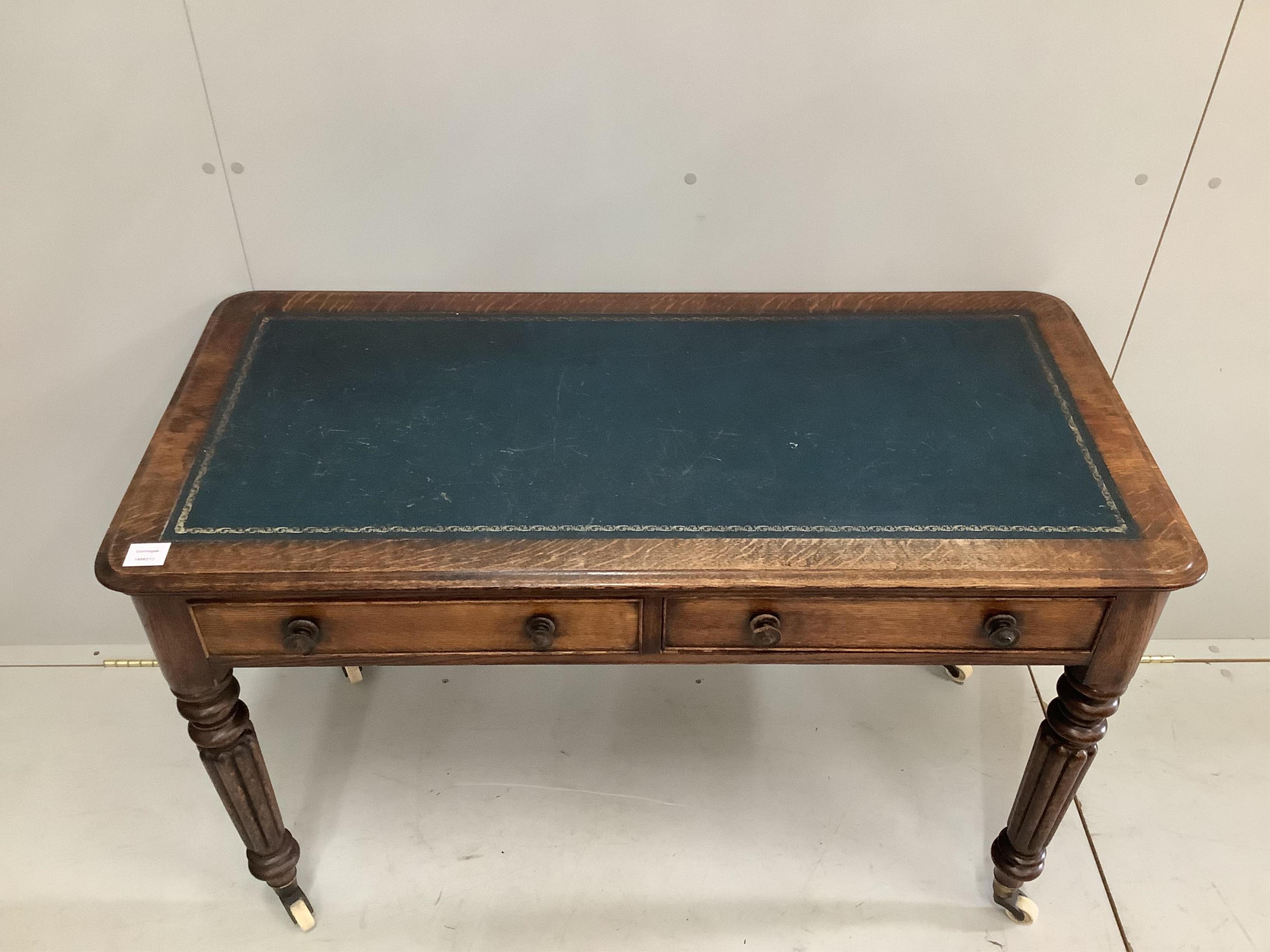 A Victorian oak two drawer writing table, width 114cm, depth 55cm, height 73cm. Condition - fair